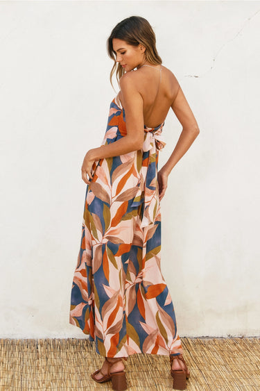 Otti Maxi Dress strapless leaf print maxi dress angled side pose showing drape and movement.