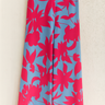 Floral patterned pants with pink flowers on a blue fabric.