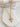 Pearl Cross Necklace featuring a gold-plated cross pendant adorned with luminous pearls on an adjustable chain, displayed on neutral stone background.