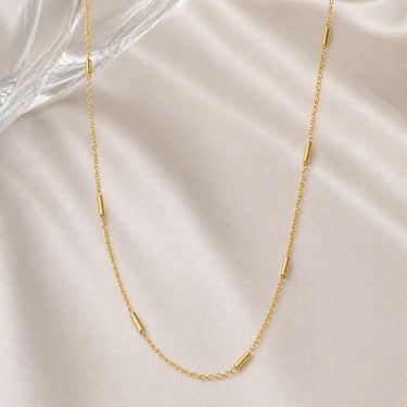 Quirk Necklace thin gold chain necklace with evenly spaced minimal bar details, designed for a lightweight, everyday layered style.