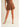 Ragit Short brown high-waisted pleated shorts full body front view, showing tailored silhouette, structured waistband, and lightweight summer fabric.