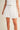Ragit Short white pleated shorts styled as a matching set, showing elevated summer outfit with relaxed tailored silhouette.