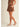 Ragit Short brown tailored shorts side profile view, highlighting fluid drape, pleated front detail, and flattering high-rise cut.