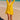 Ray Cover Up lightweight yellow beach cover-up with relaxed flowy silhouette, long sleeves, and deep V neckline, worn over swimwear on the beach.