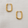 Runa Huggie Earrings — rectangular gold plated hoops on linen background, modern, lightweight, and elegant jewelry piece by Matte.
