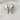 Pair of silver abstract earrings on a white fabric background
