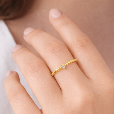 Model wearing gold ring