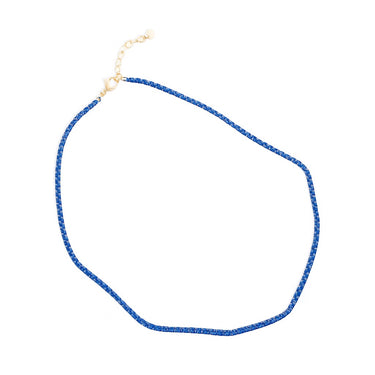 Close-up of the Samura Necklace in royal blue enamel and gold plated chain by Matte. A minimal, lightweight accessory perfect for layering or wearing solo. Modern summer jewelry.