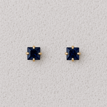 Square-cut blue sapphire stud earrings with 14K light gold prongs on a neutral background – Sapphire Muse Stud Earrings by Matte
