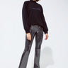 Shimmering black sequin flare pants styled with a casual sweatshirt, statement night-out look by Matte
