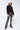 Shimmering black sequin flare pants styled with a casual sweatshirt, statement night-out look by Matte