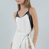 Model wearing the Lennon two-tone ivory satin cami with black faux-leather accents, slightly to the side.