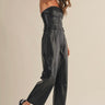 Model wearing the Melina strapless jumpsuit with relaxed straight-leg silhouette, side view.
