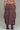 Back view of brown parachute maxi skirt showing cargo-inspired details and volume.
