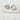 Silver artsy hoop earrings with sculptural abstract design displayed on fabric background
