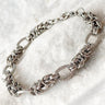 Silver chain bracelet with intricate link design on marble stone background – Solea Chain Bracelet Matte Jewelry