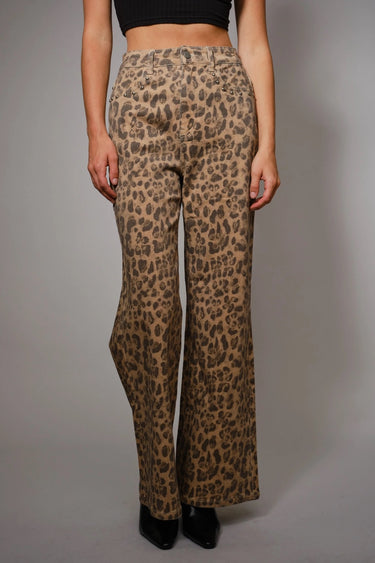 High-rise leopard-print jeans with subtle studded accents and wide-leg silhouette, photographed in soft natural light on a neutral background.