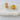 Taby Huggie in gold with rows of sparkling pavé-set crystals displayed on white stone