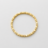 Talte Bracelet gold beaded stretch bracelet on neutral background, showing rounded and squared polished beads and easy slip-on design