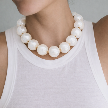 Terra Necklace white glossy bead necklace oversized pearl-style beads statement necklace on model clean minimal styling.