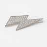 Silver lightning bolt brooch with crystal embellishments on a white background