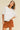 Toto Crop Top front view on model wearing oversized white crewneck tee.