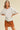 Toto Crop Top angled view on model highlighting dropped shoulders and loose silhouette.