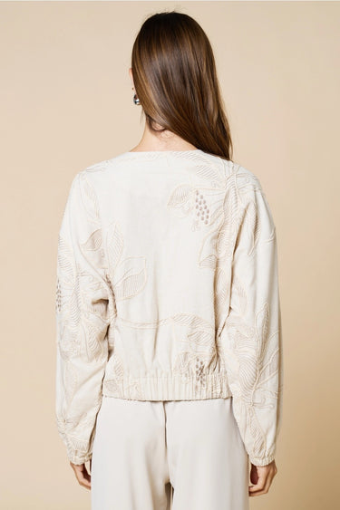 Tuci Jacket worn by model, back view, highlighting embroidered texture and clean relaxed shape.