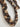 Close-up of Twilight Sequin Rope Necklace showing twisted braid with shimmering sequins in gold, bronze, and charcoal tones