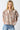 Tyrath Blouse leopard print blouse with puff sleeves and button-front design, featuring a relaxed airy fit and neutral animal print, styled with blue denim on model against white studio background.