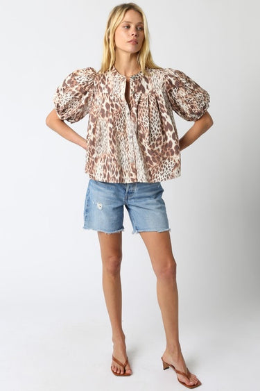 Tyrath Blouse full body look featuring leopard print blouse styled with blue jeans and sandals, demonstrating versatile fit for brunch, office, or casual day-to-night outfits.