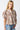 Tyrath Blouse animal print puff sleeve blouse shown from angled front view, highlighting dramatic sleeves, soft drape, and polished button-front styling paired with casual denim.