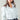 Cropped white jacket with utility details, styled with streetwear look