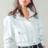 Cropped white jacket with utility details, styled with streetwear look
