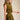Uvek Top olive and gold striped sleeveless top worn with matching skirt, showing fitted waist and flowing silhouette.