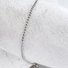 Silver beaded bracelet on white marble background – Atina Bracelet