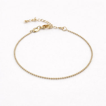 Gold bracelet on a white background