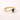 Voluspa Ring gold band with blue pear-shaped gemstone on neutral background