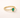 Voluspa Ring gold band with green pear-shaped gemstone on neutral background