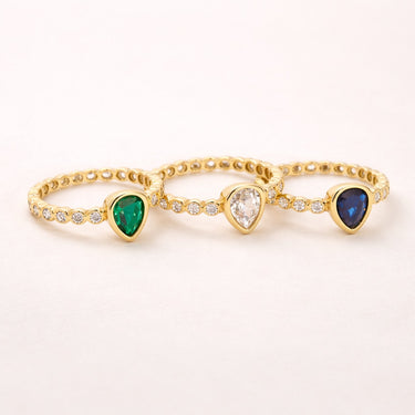 Voluspa Rings placed together highlighting crystal band detail and colored stones.