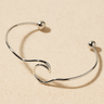 Waves Cuff Bracelet — sculptural silver open cuff bracelet with wavy design and polished sphere ends on beige background, minimal and elegant by Matte.