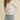 Model wearing white Essential Long Sleeve Tee by Matte with denim shorts, front view