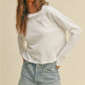 Model wearing white Essential Long Sleeve Tee by Matte with denim shorts, front view