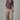 Wide-leg leopard print pants styled with brown long-sleeve top.