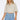 Wims Cropped Shirt worn by model, front view, featuring relaxed short sleeves, button-front design, and elasticated hem.