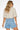 Wims Shirt worn by model, full body back view, styled with denim shorts, showing cropped fit and lightweight fabric.