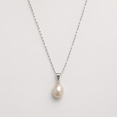 Wull Pearl Necklace close-up of pearl pendant on fine chain against neutral background, highlighting smooth pearl and silver polished finish