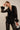 Yanz Mesh Top sheer feather-trim top styled with black pants full outfit posed.