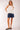 Side view of Yui Sleeveless Ruffle Detail Top showing relaxed sleeveless fit and soft ruffle accent.