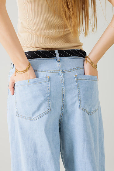 Zaria Jeans detail view of light-wash denim fabric and relaxed fit